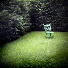 photo of a blue chair on green grass